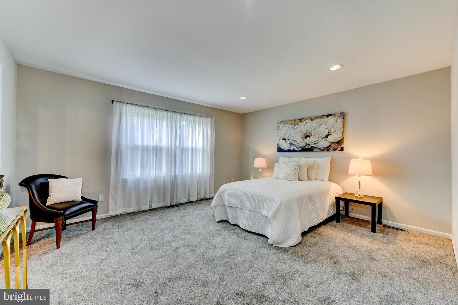 5 Glengarry Way Princeton Junction, NJ 08550 - Photo 32 of 63 a spacious bedroom with a bed and a chair in it