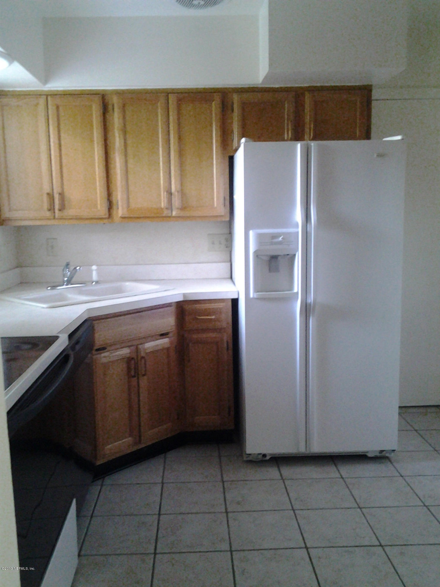 2131 Goltare Drive Jacksonville, FL 32216 - Photo 4 of 25 a kitchen with a sink a refrigerator and cabinets