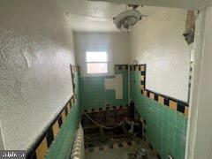 1108 West 3rd Street Chester, PA 19013 - Photo 40 of 75 a bathroom with a sink a toilet and shower