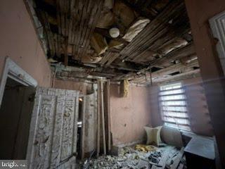 1108 West 3rd Street Chester, PA 19013 - Photo 67 of 75 a bed sitting in a bedroom next to a window and a chair