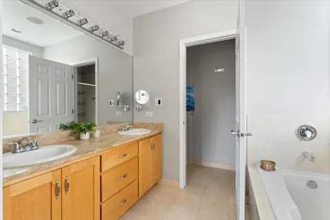 a spacious bathroom with a granite countertop sink mirror and shower