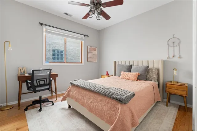 a bedroom with a bed a table and chair