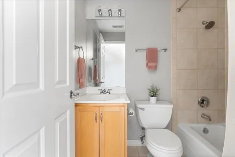 a bathroom with a granite countertop toilet a sink and a bathtub