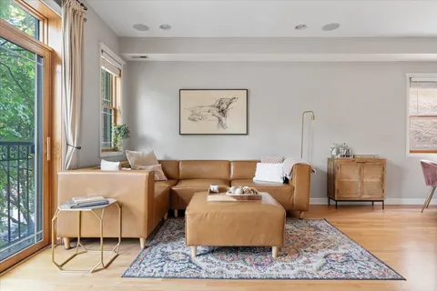 a living room with furniture rug and window