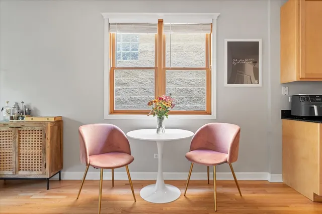 a dining room with furniture and a window