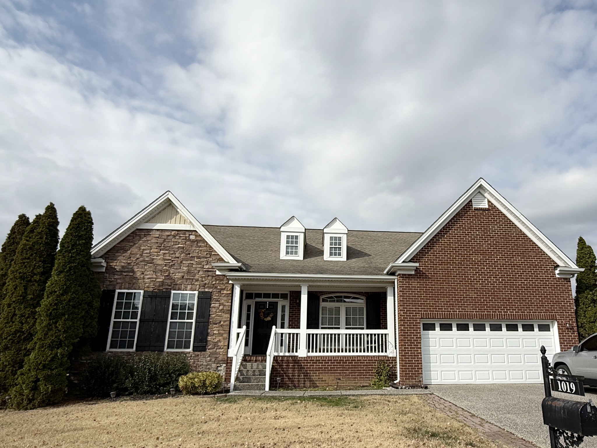 1019 Queens Place Spring Hill, TN 37174 - Photo 1 of 18 a front view of a house with a yard