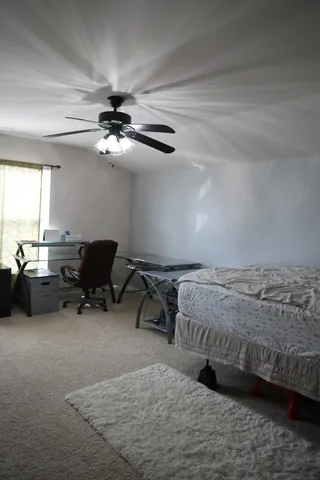 a bedroom with bed and a chandelier