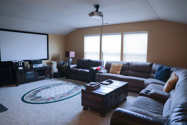 a living room with furniture a dining table and a window