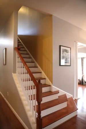 a view of entryway and hall with wooden floor