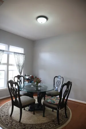 a dining room with furniture and window