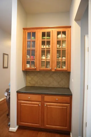view of kitchen with granite countertop cabinets and window