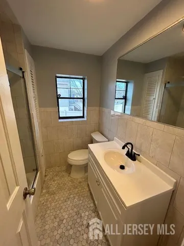 a bathroom with a sink a toilet and mirror