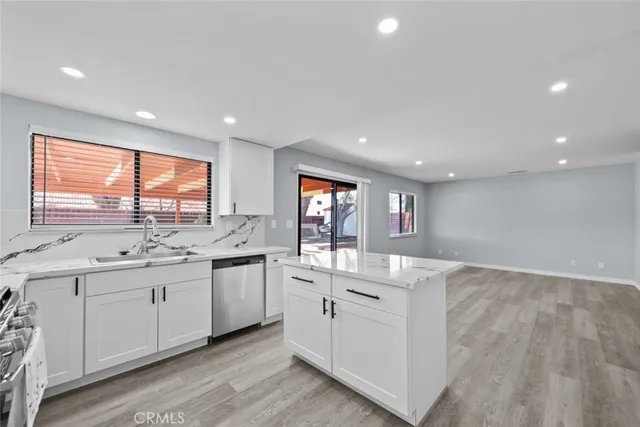 a kitchen with a sink stove and cabinets