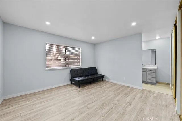 a living room with a bed furniture and a window
