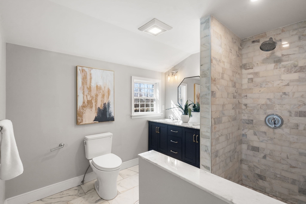 25 Charles Street Hingham, MA 02043 - Photo 14 of 32 a bathroom with a sink a toilet and shower