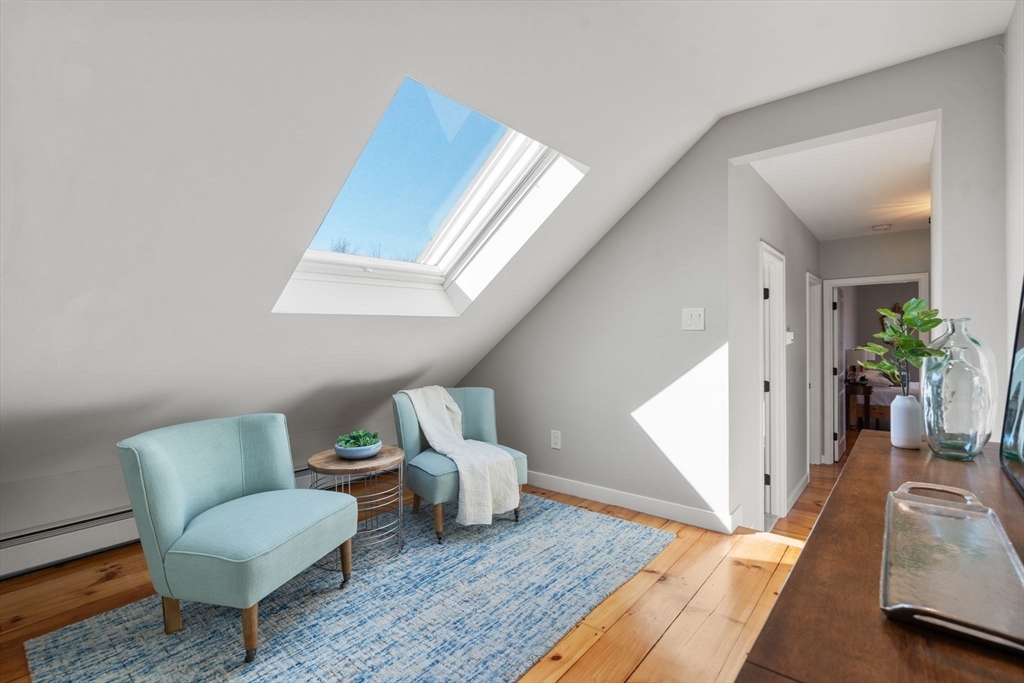 25 Charles Street Hingham, MA 02043 - Photo 19 of 32 a living room with furniture and a rug