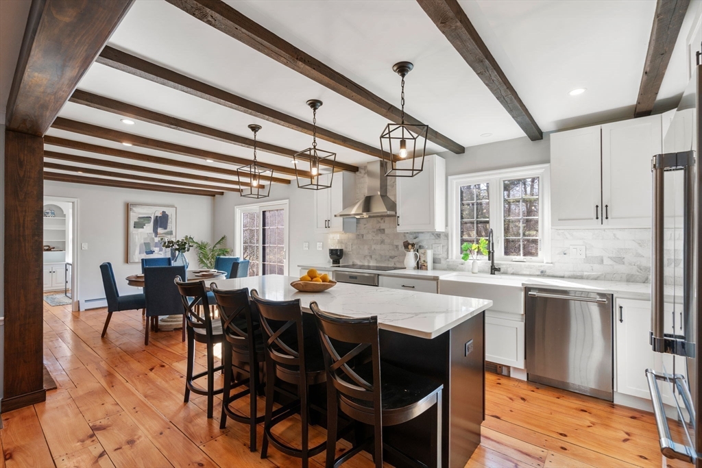 25 Charles Street Hingham, MA 02043 - Photo 2 of 32 a dining hall with stainless steel appliances a table and chairs
