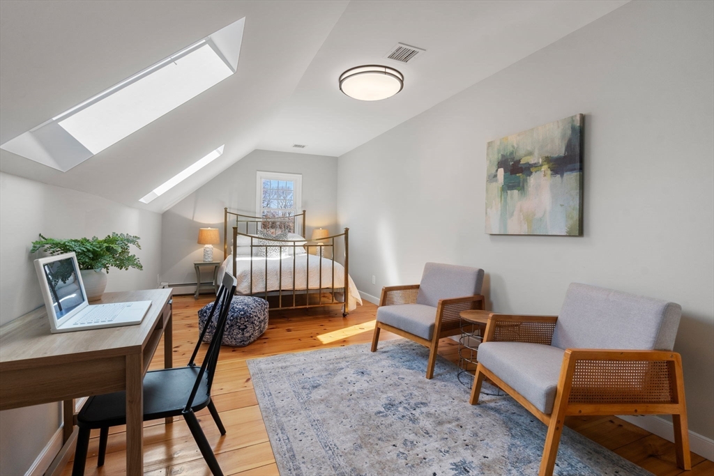 25 Charles Street Hingham, MA 02043 - Photo 21 of 32 a living room with furniture and a lamp