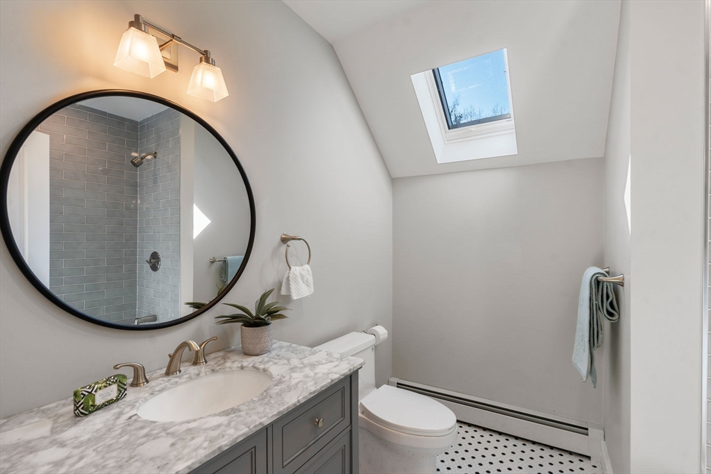 25 Charles Street Hingham, MA 02043 - Photo 22 of 32 a bathroom with a granite countertop sink mirror and toilet