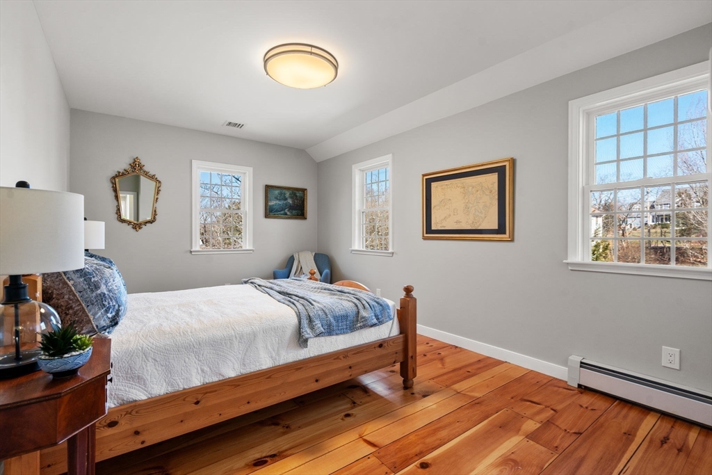 25 Charles Street Hingham, MA 02043 - Photo 23 of 32 a bedroom with a bed and wooden floor