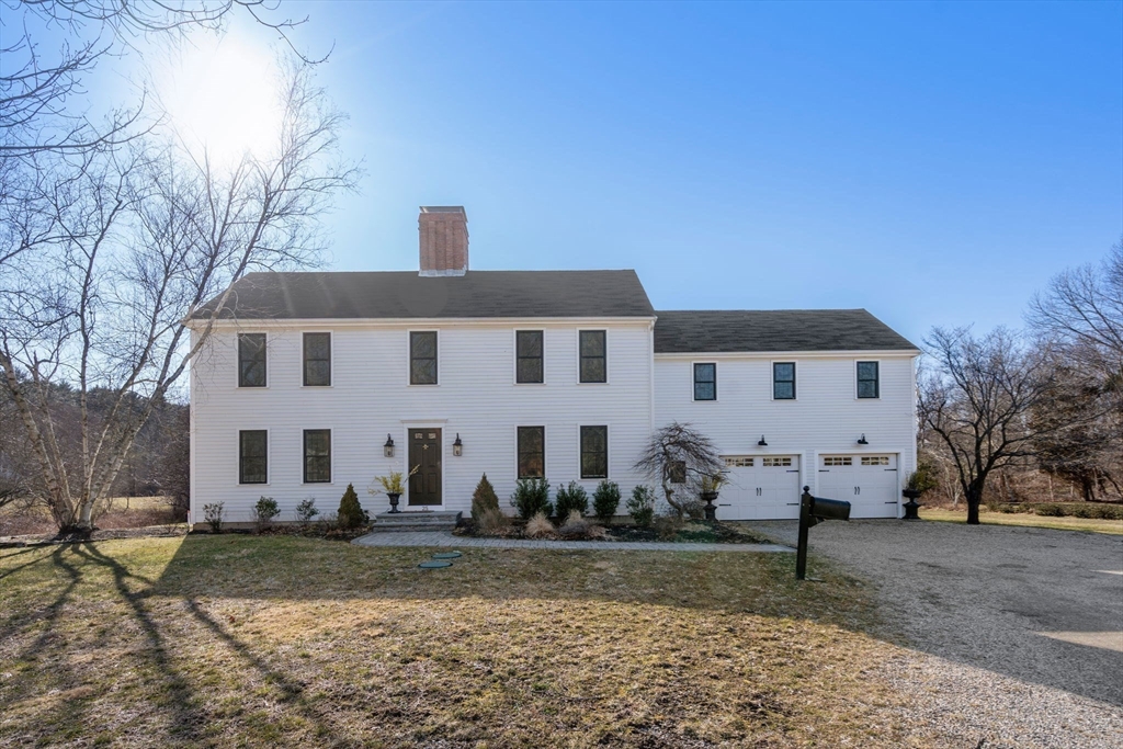 25 Charles Street Hingham, MA 02043 - Photo 25 of 32 a view of a white house with a yard