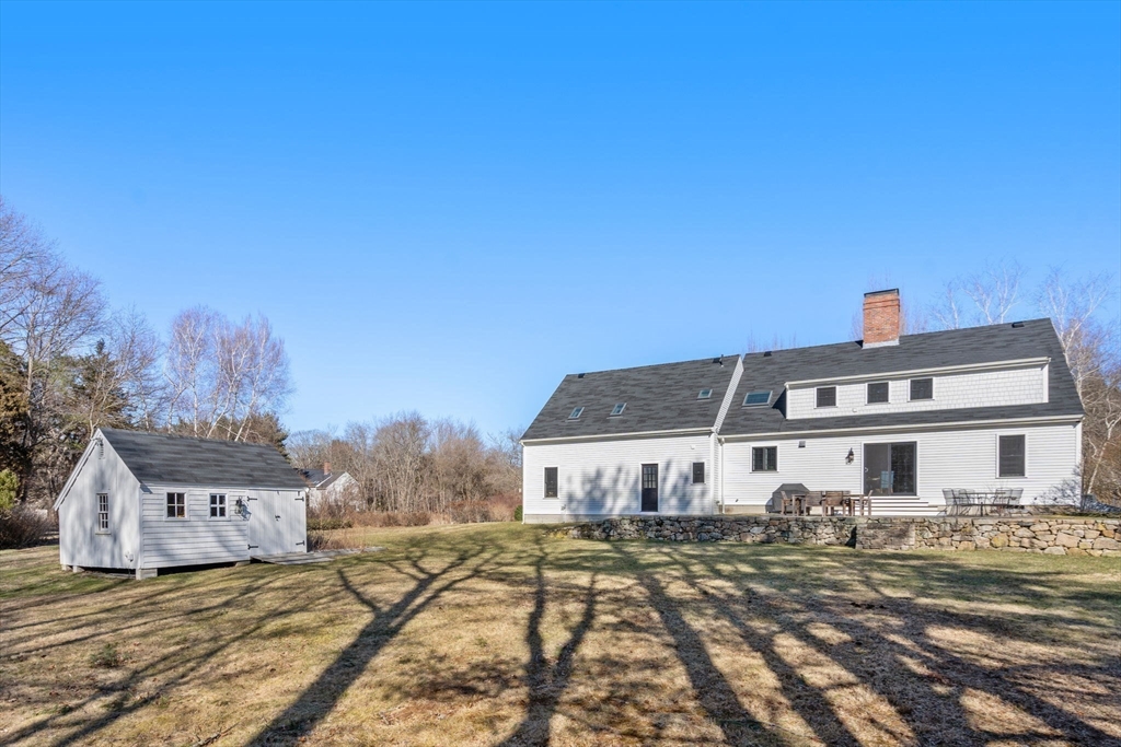 25 Charles Street Hingham, MA 02043 - Photo 26 of 32 a view of a big house with a big yard and large trees