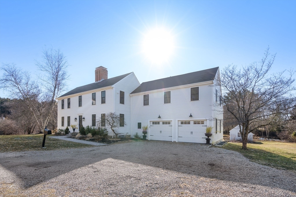 25 Charles Street Hingham, MA 02043 - Photo 30 of 32 a front view of a house with a yard