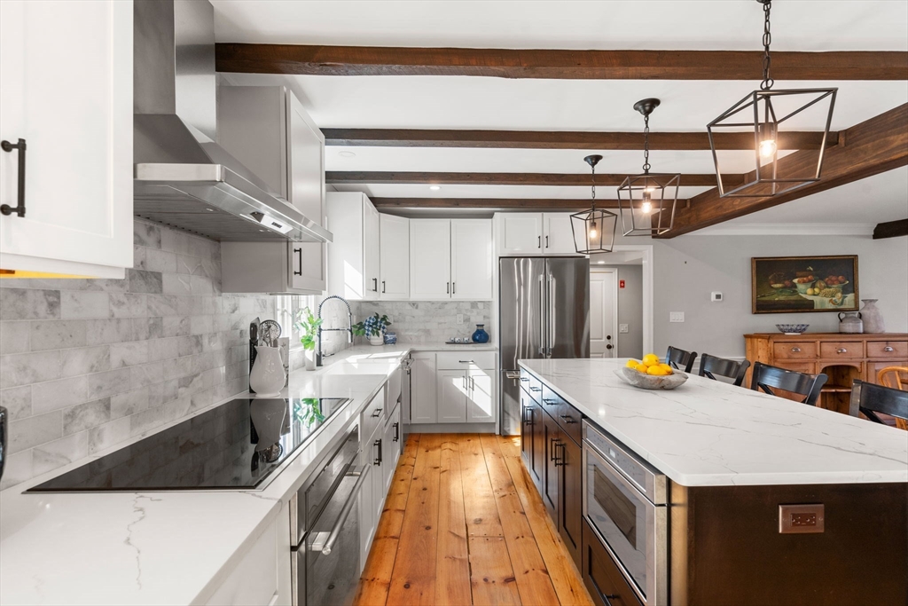 25 Charles Street Hingham, MA 02043 - Photo 3 of 32 a kitchen with a sink a counter top space and stainless steel appliances