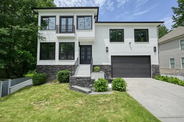 a front view of a house with garden
