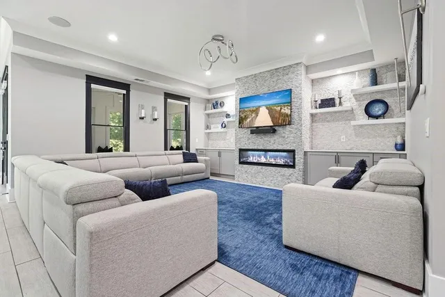 a large kitchen with stainless steel appliances a large counter top a stove and a sink