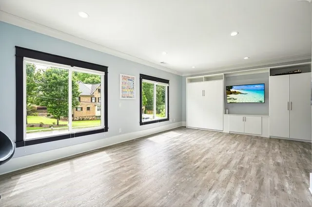 a bedroom with a bed and a large mirror