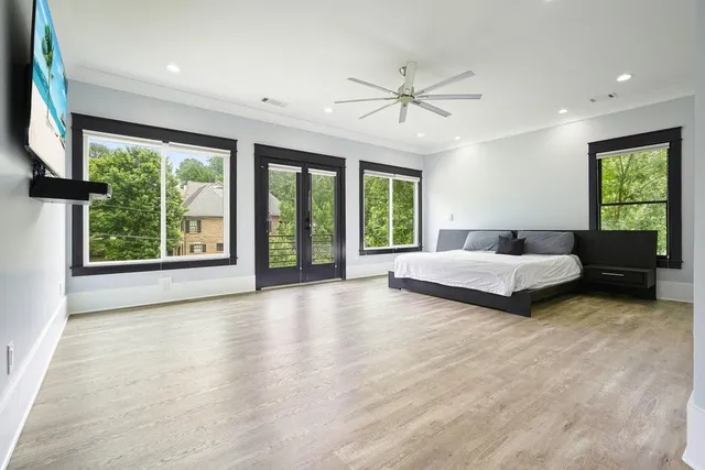 a living room with furniture and large windows