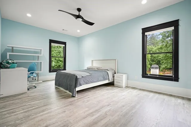 an aerial view of a residential houses with yard