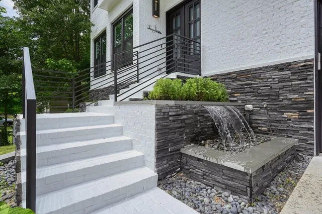 a view of entryway with wooden floor and a front door