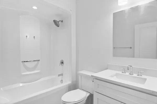 a bathroom with a sink toilet vanity and shower