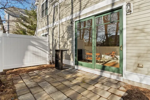 a view of a porch with wooden floor and a bench
