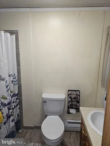 a white toilet sitting next to a sink