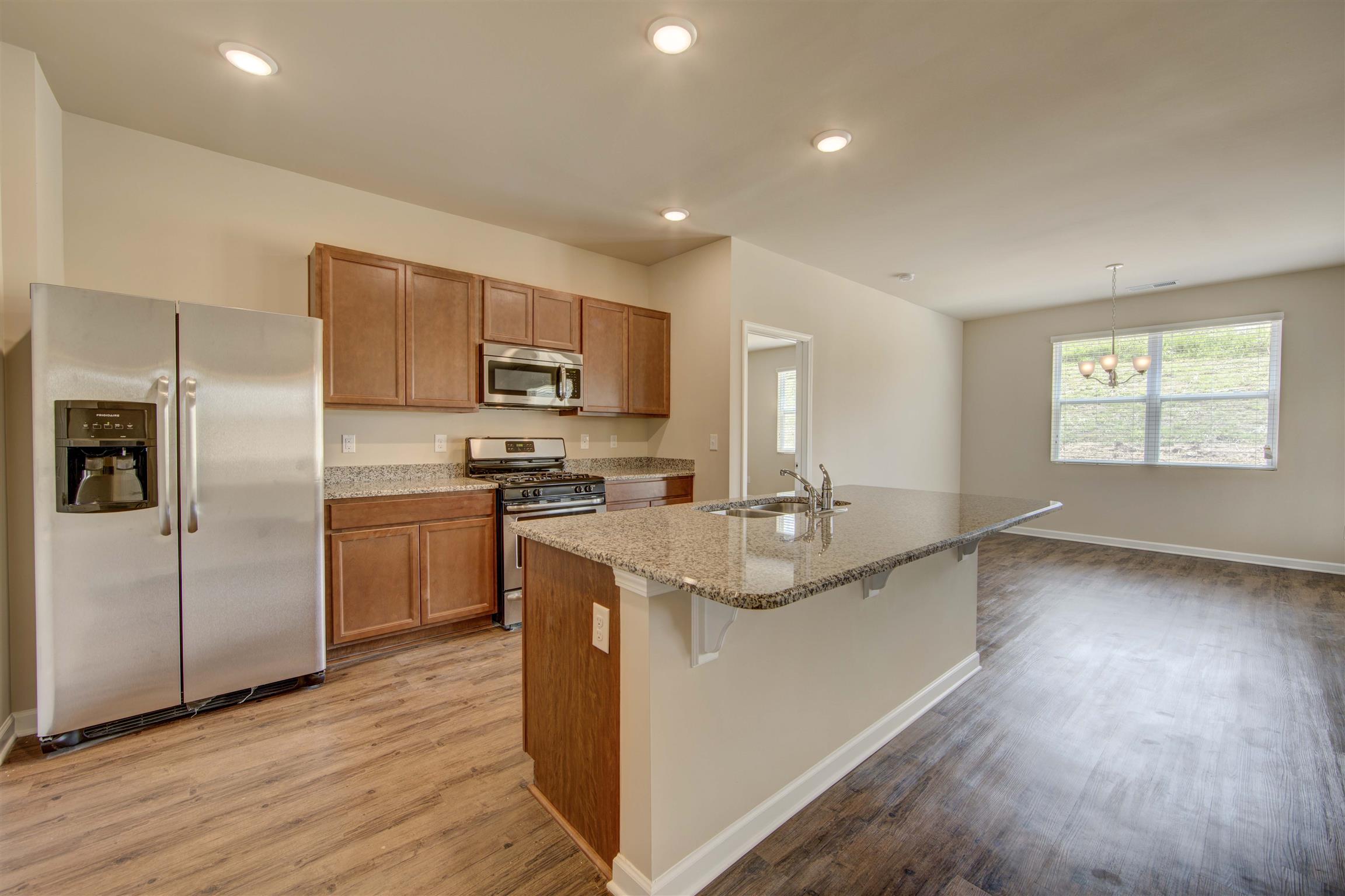 Kitchen - Photos are of same floor plan - Construction on lot 63 has not started.