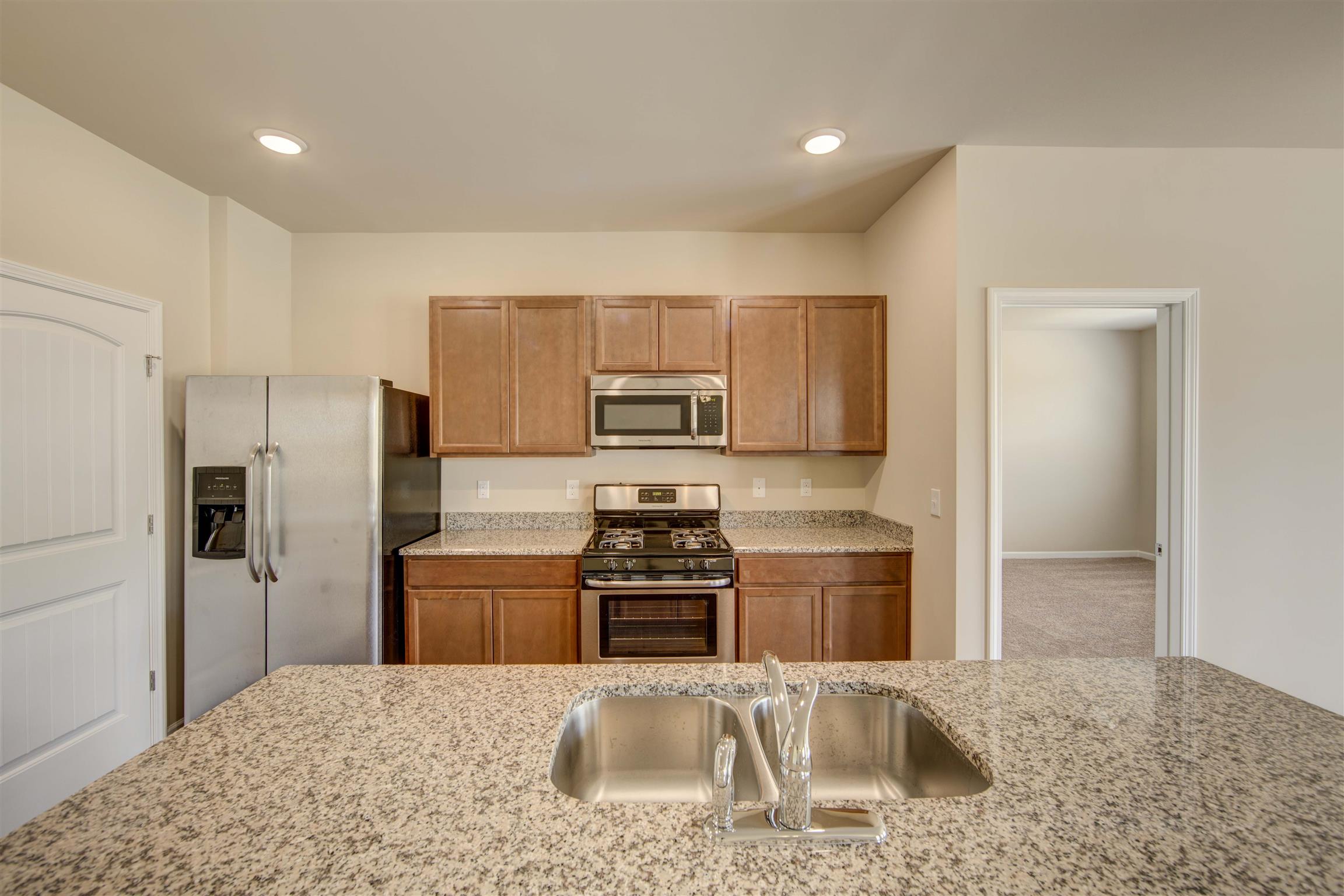 Kitchen - Photos are of same floor plan - Construction on lot 63 has not started.