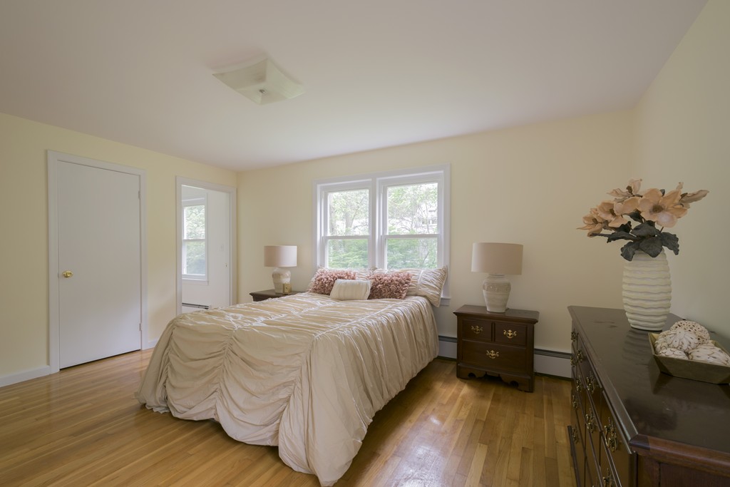 5 Garfield Street Lexington, MA 02421 - Photo 15 of 30 a bedroom with a bed and wooden floor