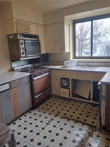 a kitchen with a stove a sink and a refrigerator