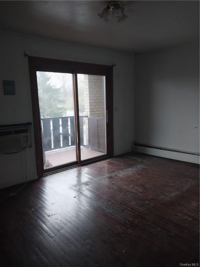 250 North Main Street, Unit F5 Spring Valley, NY 10977 - Photo 5 of 10 a view of an empty room with wooden floor and a window