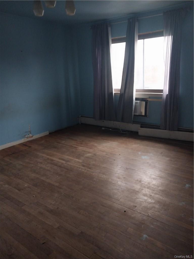 250 North Main Street, Unit F5 Spring Valley, NY 10977 - Photo 9 of 10 an empty room with wooden floor and windows