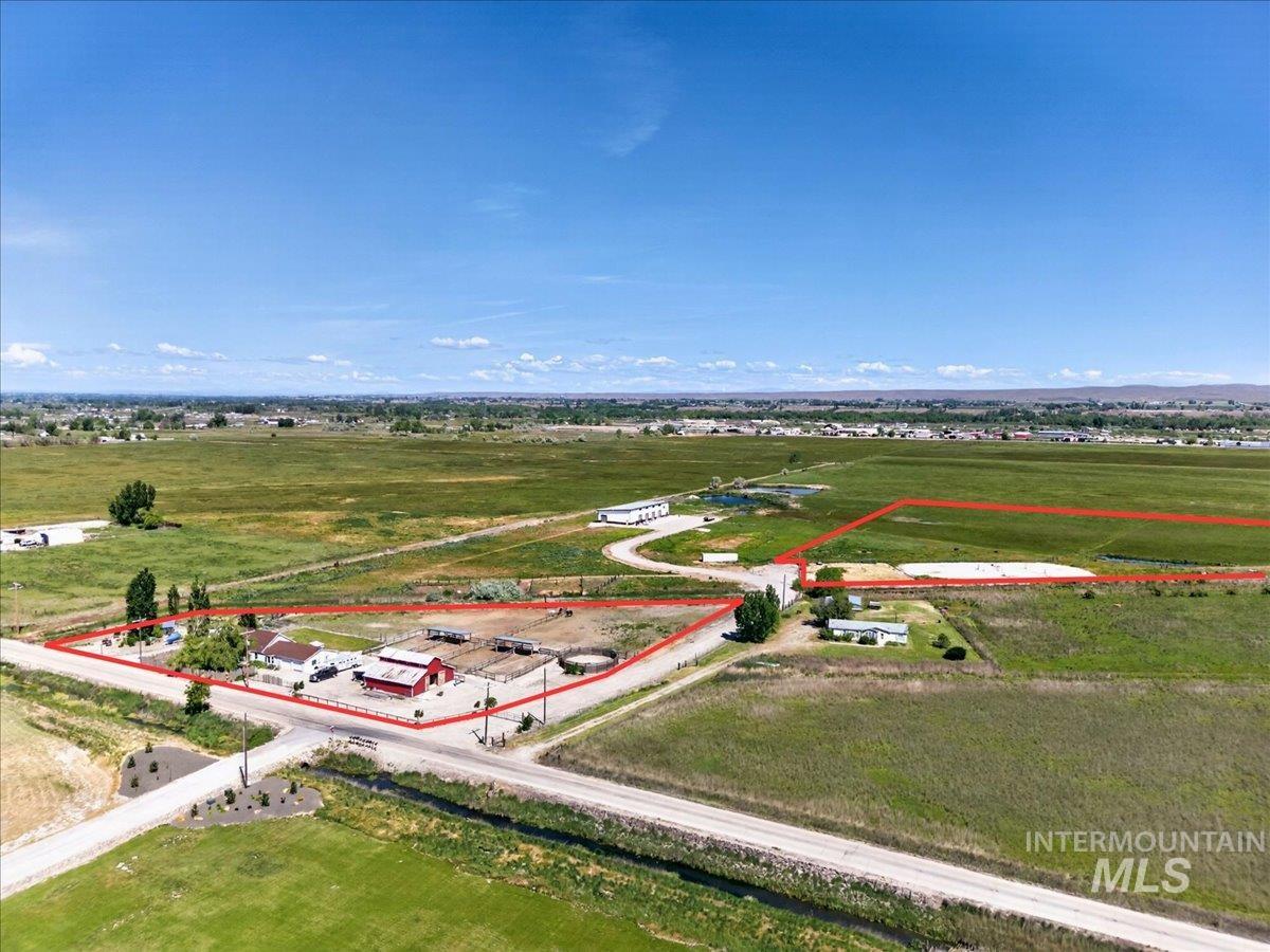 2588 West Sales Yard Road Emmett, ID 83617 - Photo 48 of 49 Expansive property featuring multiple structures, including a primary residence, a red barn, and additional outbuildings