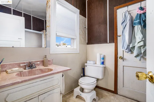 a spacious bedroom with a bed and a flat screen tv