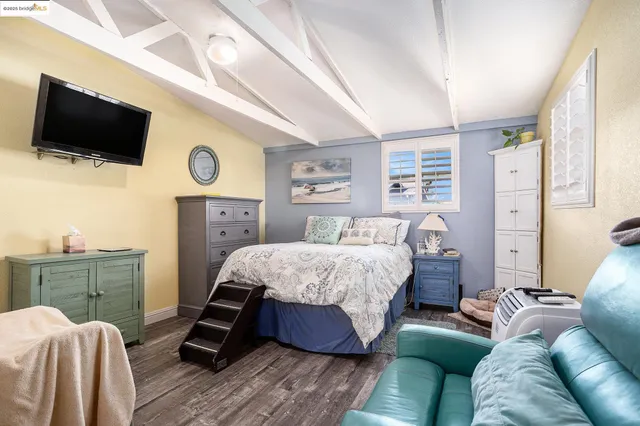 a bedroom with a bed and a flat screen tv