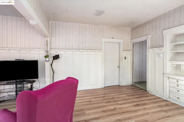 a view of a livingroom with furniture and a flat screen tv