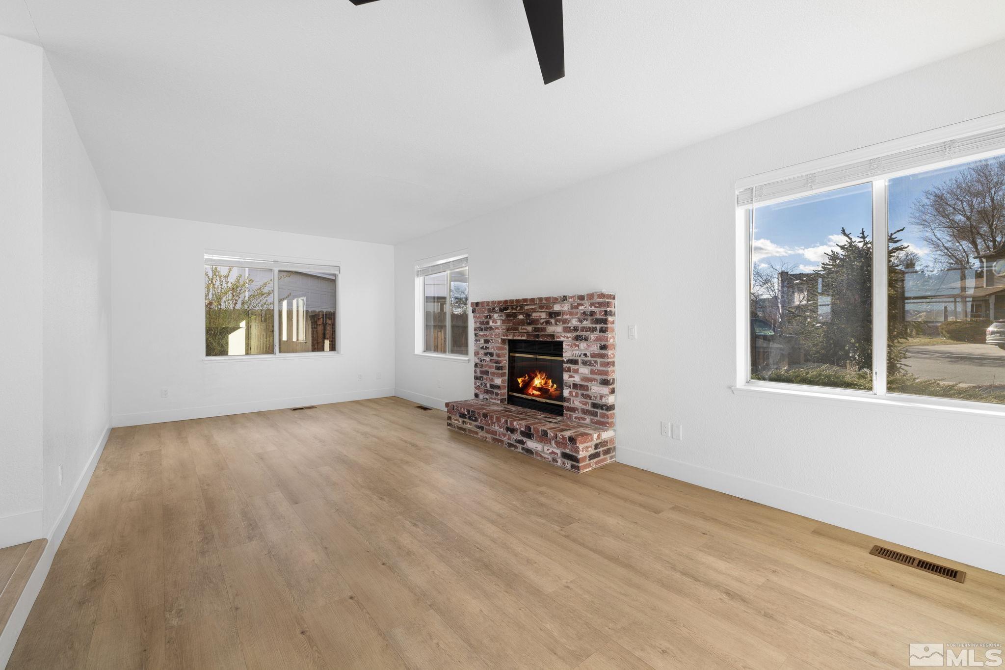 2170 Cobblestone Court Reno, NV 89503 - Photo 13 of 40 an empty room with windows and a fireplace