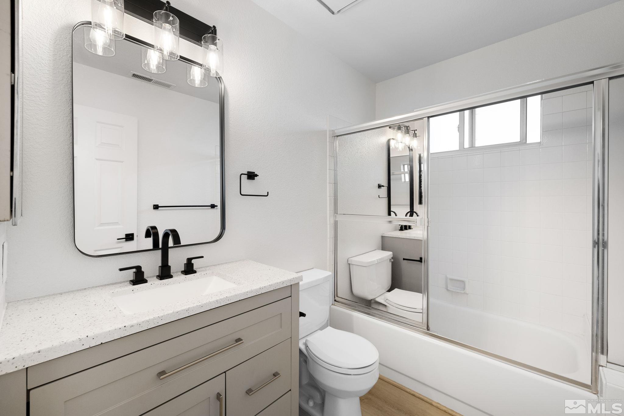 2170 Cobblestone Court Reno, NV 89503 - Photo 36 of 40 a bathroom with a sink a toilet a mirror and shower