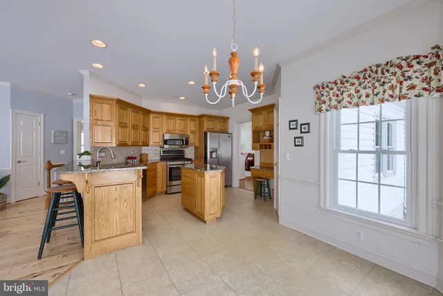 a dining room with furniture a chandelier and wooden floor